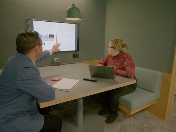 Two people looking at a document on a screen